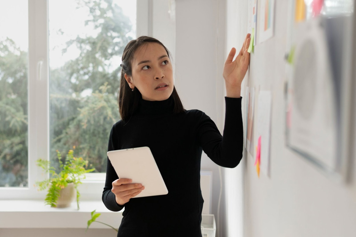 ACRA Corporate Governance Standards A female employee pointing to ACRA related guidelines on a whiteboard