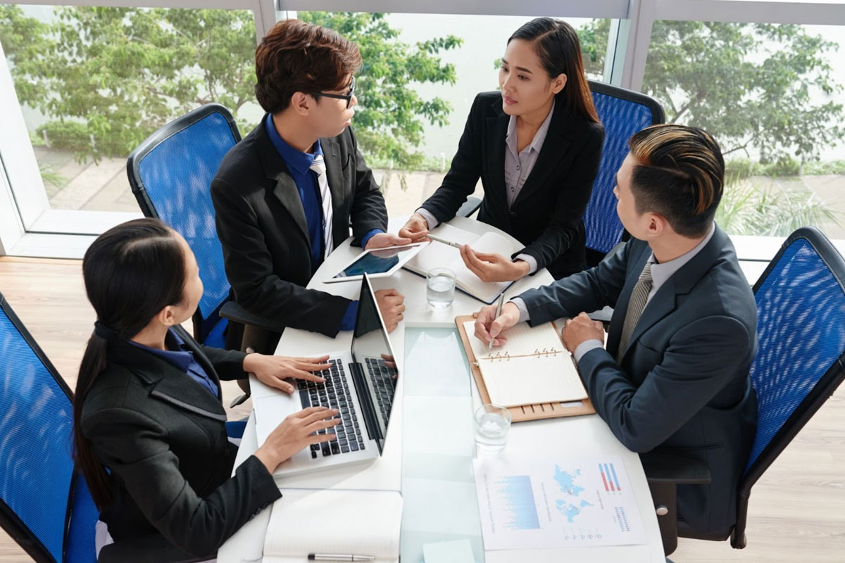 Directors' Report and Financial Statements A team of directors reviewing and signing financial statements in a boardroom.