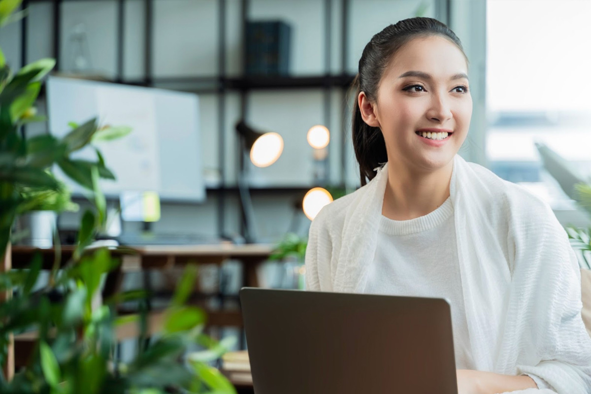Singapore vs China Key Differences Asian Female Employee Smiling at Workplace