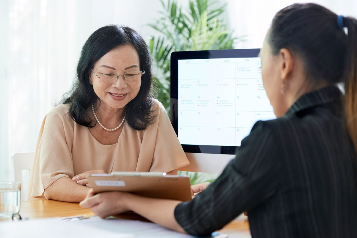 Adviser explaining key changes to Singapore SFO licensing rules to a family client