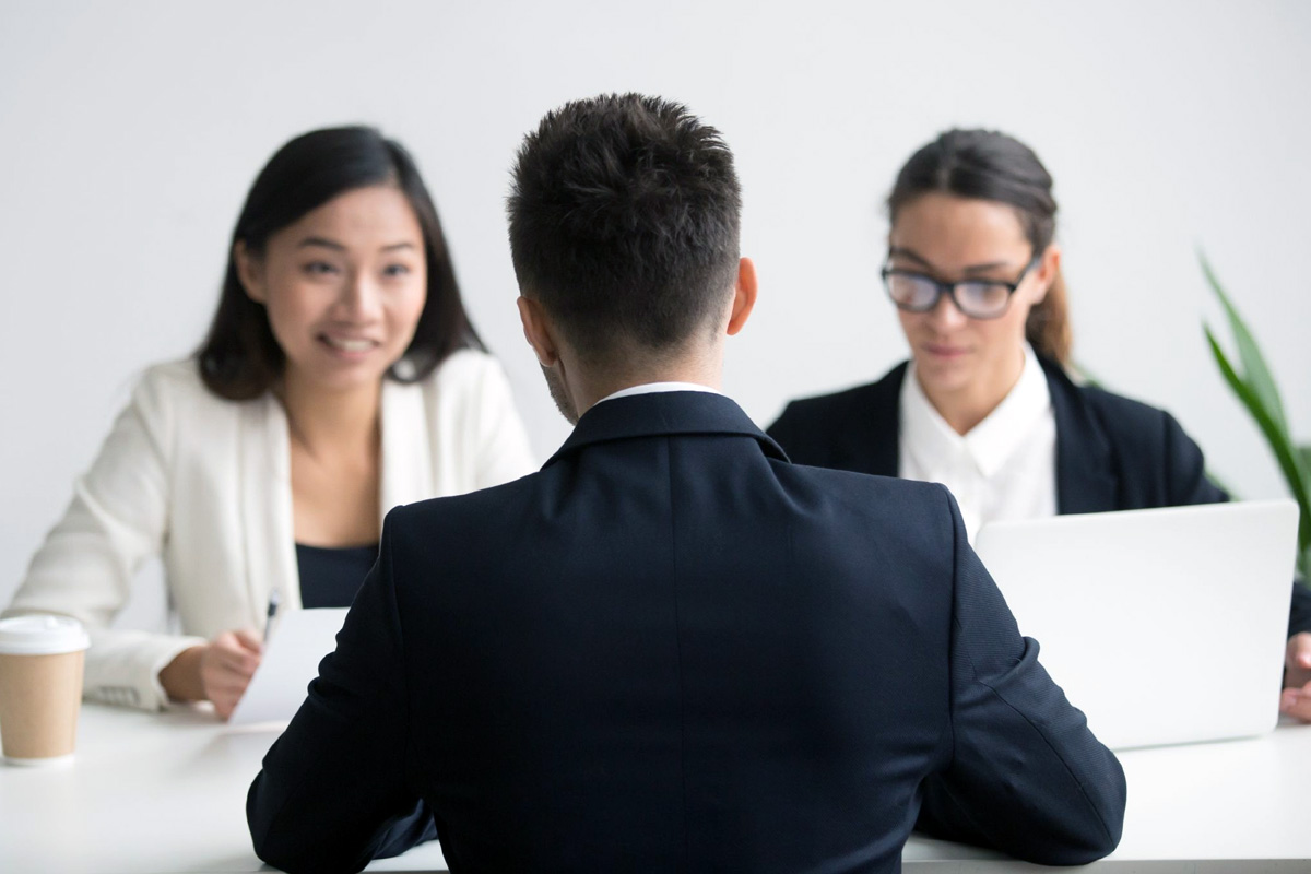 The Hidden Cost of In-House Hiring in Singapore Business owner shaking hands with an outsourced recruitment partner in a Singapore office