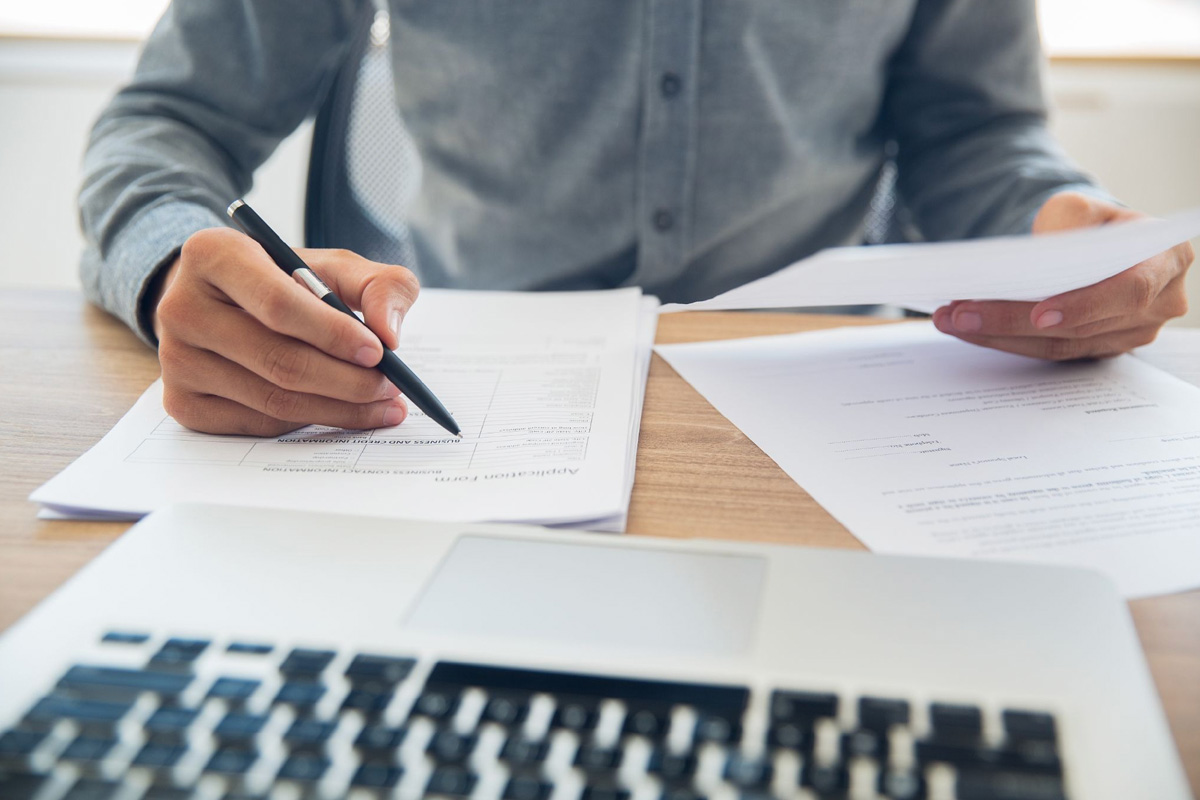 Business interruption insurance in Singapore explained Business owner reviewing a business interruption insurance policy to check coverage, exclusions, and the indemnity period.